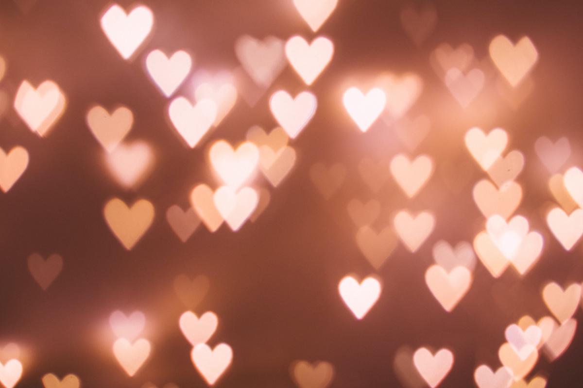 Illustration of a person holding a heart-shaped mirror reflecting a happy face, representing the benefits of self-love.