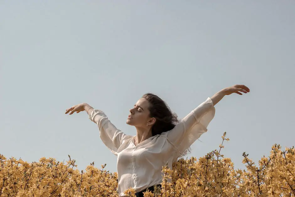 A person in a yoga pose with their hands together in front of their chest in a field of flowers